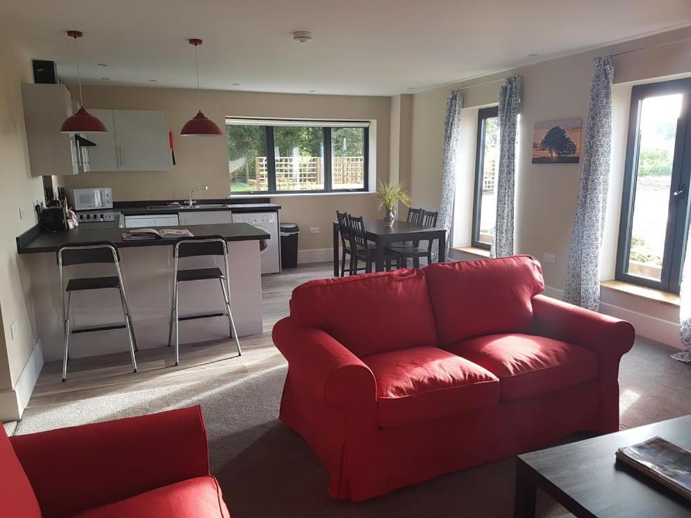 Barn holiday apartment lounge looking into the kitchen at Heath Rown Barn Holiday lets in Hampshire countryside